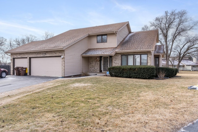 view of property featuring a garage and a front lawn