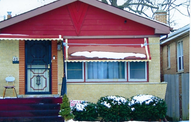 49 W 83rd St, Chicago, IL 60620 - view of front of home featuring a chimney and brick siding