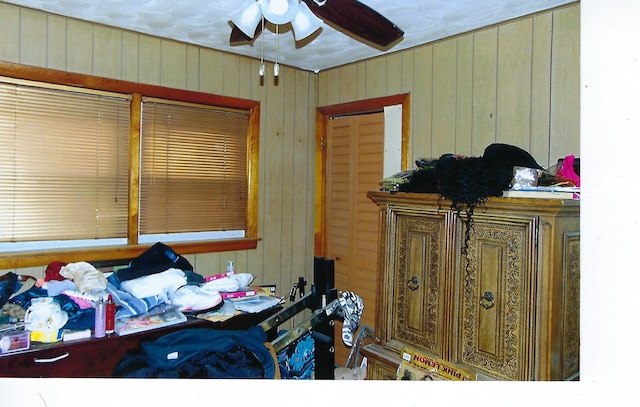 49 W 83rd St, Chicago, IL 60620 - bedroom featuring a ceiling fan and wooden walls