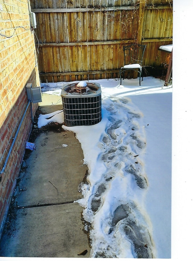 49 W 83rd St, Chicago, IL 60620 - details featuring central AC unit, fence, and brick siding