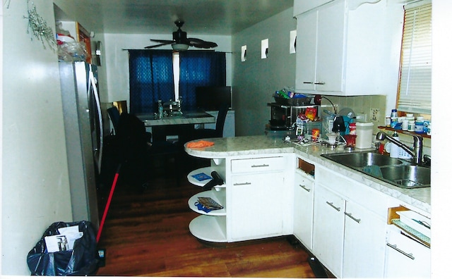 49 W 83rd St, Chicago, IL 60620 - kitchen with light countertops, white cabinetry, ceiling fan, a sink, and a peninsula