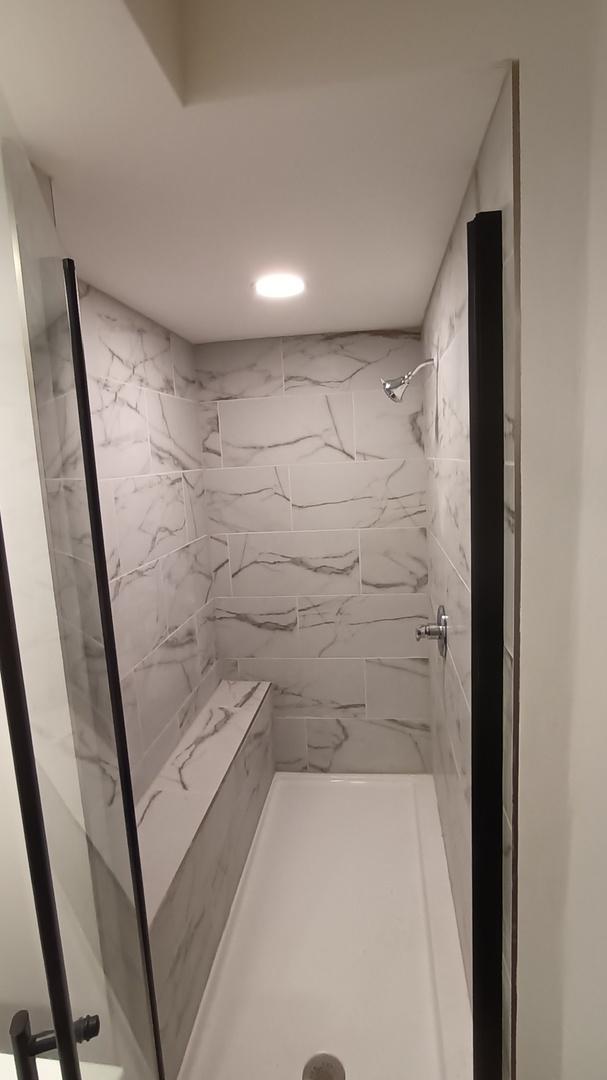 bathroom with a shower stall