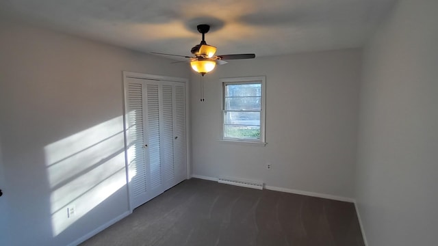 unfurnished bedroom featuring a ceiling fan, a baseboard radiator, baseboards, and a closet