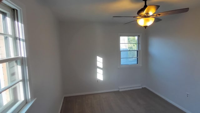 spare room with baseboards, ceiling fan, baseboard heating, and wood finished floors