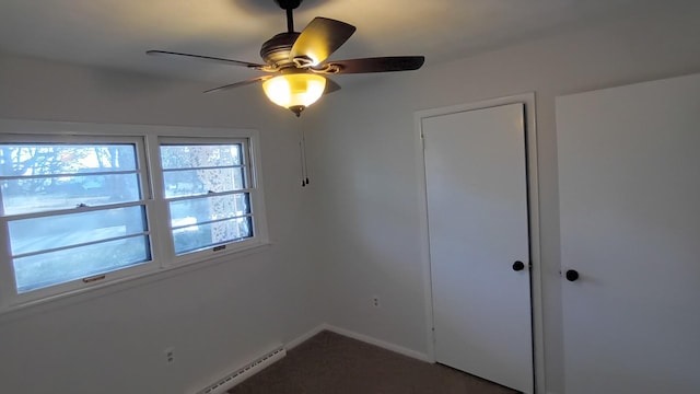 unfurnished bedroom with baseboards, ceiling fan, and baseboard heating