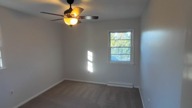 carpeted spare room featuring baseboard heating, a ceiling fan, and baseboards