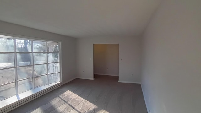 spare room featuring baseboard heating and baseboards