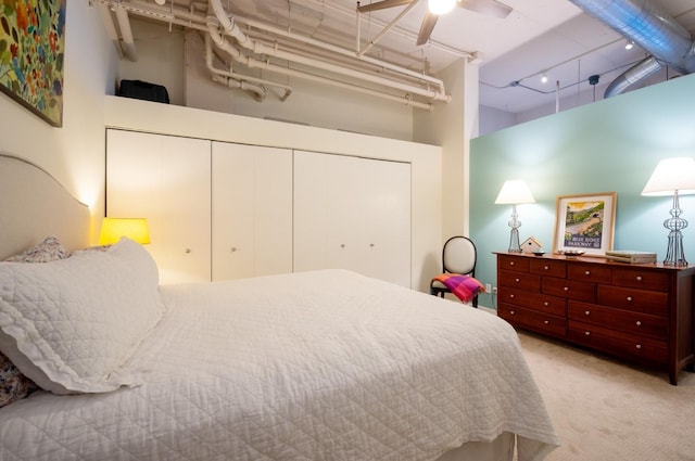 bedroom featuring a high ceiling, ceiling fan, track lighting, a closet, and carpet flooring