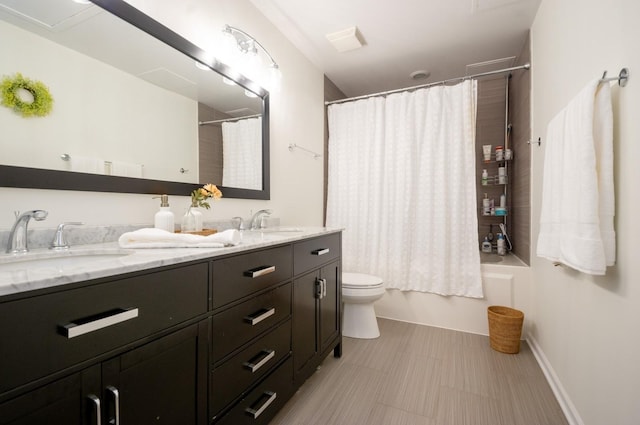 full bathroom featuring double vanity, toilet, shower / tub combo with curtain, and a sink