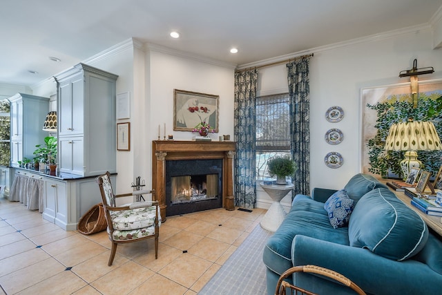 sitting room with light tile patterned floors, a warm lit fireplace, crown molding, and recessed lighting