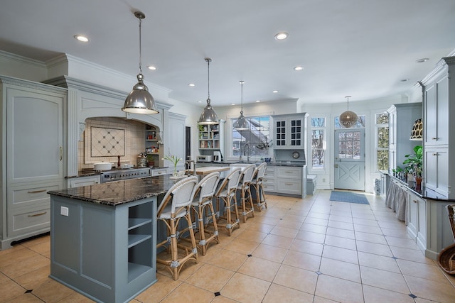 kitchen with a healthy amount of sunlight, light tile patterned floors, and open shelves