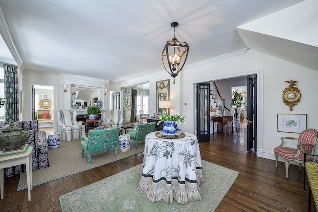 living room with a notable chandelier, crown molding, wood finished floors, and stairs