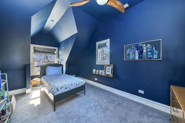 carpeted bedroom with baseboards and vaulted ceiling