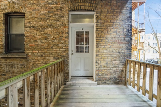 property entrance featuring brick siding