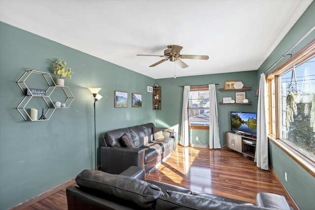 living room with ceiling fan, wood finished floors, and baseboards