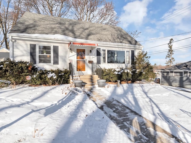 view of front of house featuring entry steps and a shingled roof