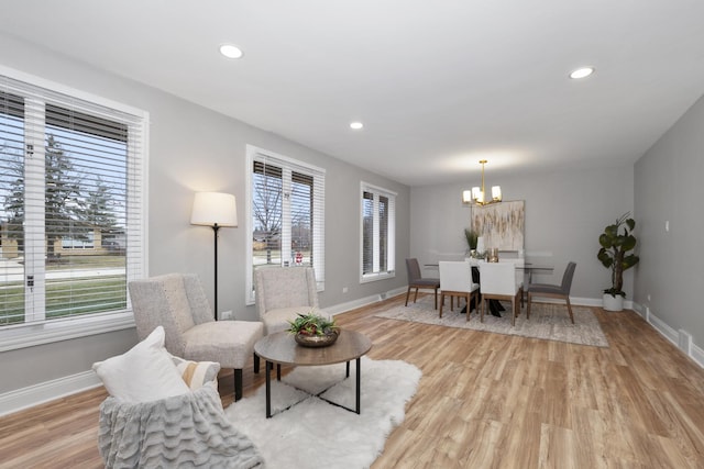 dining area with an inviting chandelier and light wood-type flooring