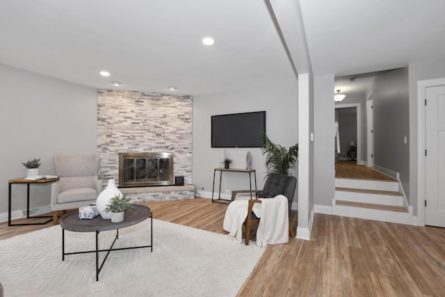 living room featuring a large fireplace and light hardwood / wood-style floors