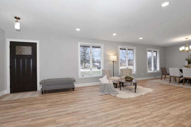 interior space with a notable chandelier and light wood-type flooring