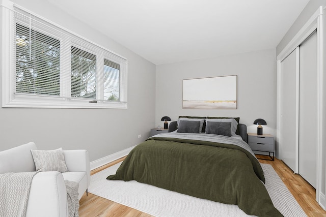 bedroom featuring light hardwood / wood-style floors and a closet