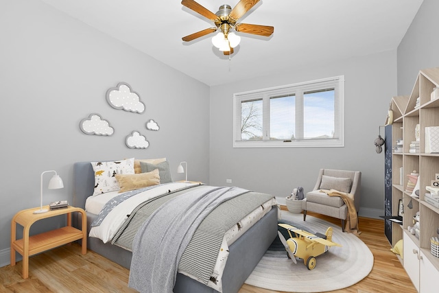 bedroom with ceiling fan and light hardwood / wood-style floors