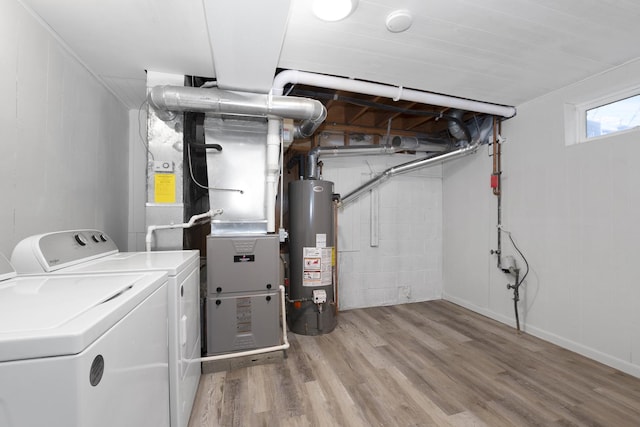 washroom featuring light hardwood / wood-style flooring, gas water heater, and independent washer and dryer