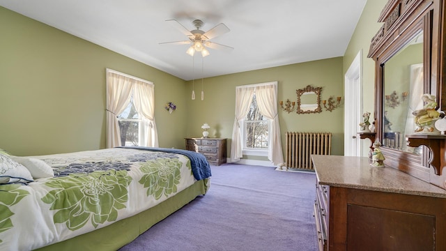 bedroom with ceiling fan, radiator, and carpet