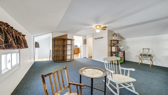 living area with vaulted ceiling, carpet floors, and ceiling fan