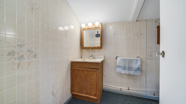 bathroom with vanity and tile walls