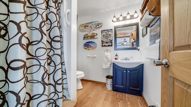 bathroom with vanity, hardwood / wood-style floors, and toilet