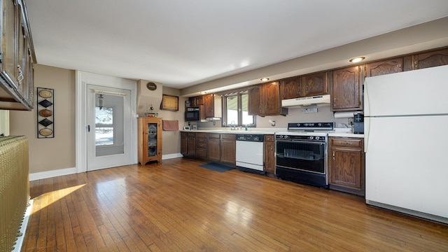 kitchen featuring white appliances and light hardwood / wood-style floors