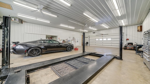 garage with a garage door opener and ceiling fan