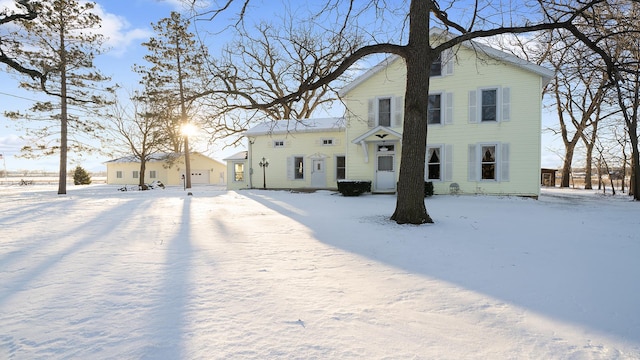 view of snow covered rear of property