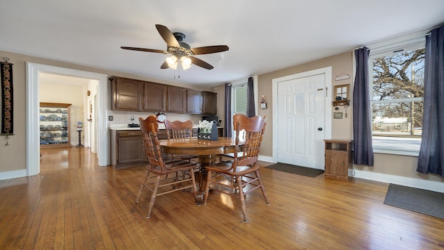 dining room with light hardwood / wood-style floors and ceiling fan