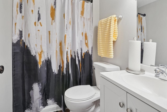 bathroom with vanity, toilet, and curtained shower