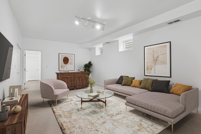 living room featuring visible vents, light carpet, and rail lighting