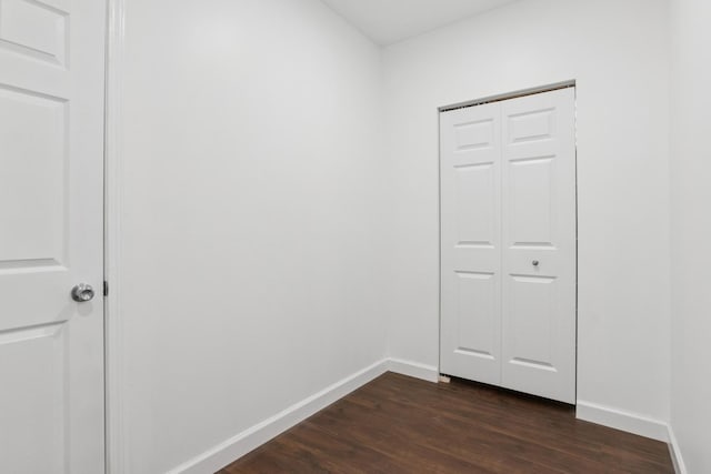 interior space with dark wood finished floors and baseboards