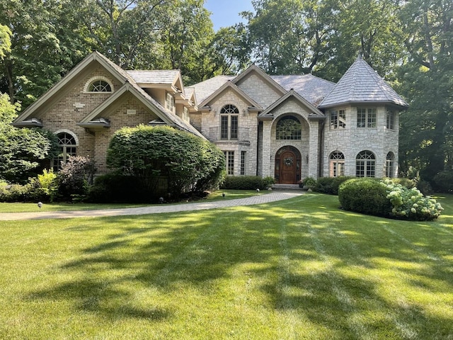 french provincial home with a front lawn