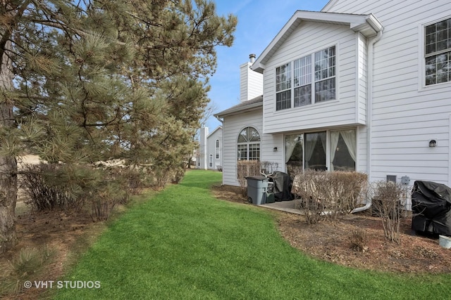 rear view of property featuring a lawn