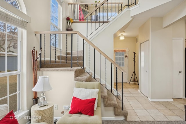 tiled foyer featuring a towering ceiling