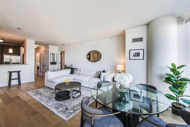 living area featuring wood finished floors and visible vents