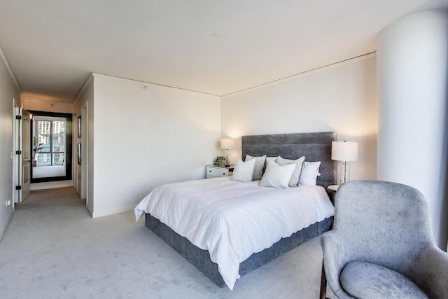 bedroom featuring light carpet and baseboards