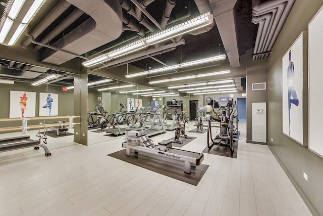 workout area with visible vents and wood finished floors