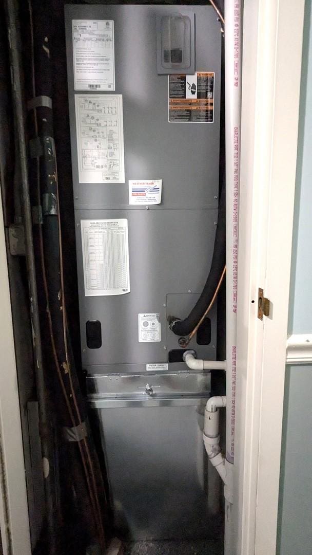 utility room featuring heating unit