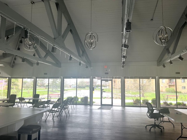 sunroom / solarium featuring a chandelier, beamed ceiling, and plenty of natural light