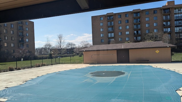 view of swimming pool with fence