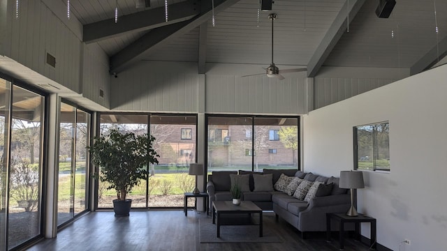 sunroom featuring beamed ceiling, outdoor lounge area, and ceiling fan