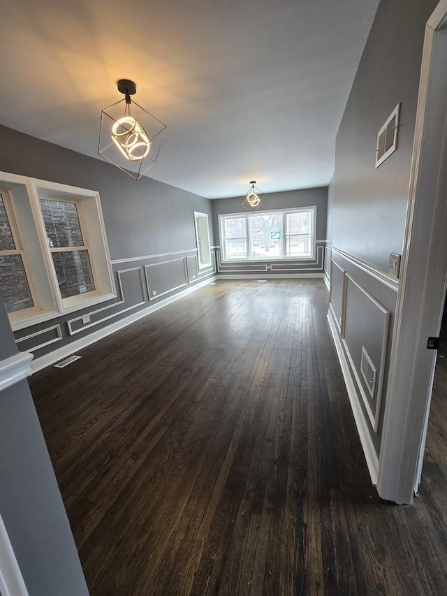 2040 W Garfield Blvd, Chicago, IL 60609 - unfurnished living room with a decorative wall, wainscoting, visible vents, and dark wood-style flooring
