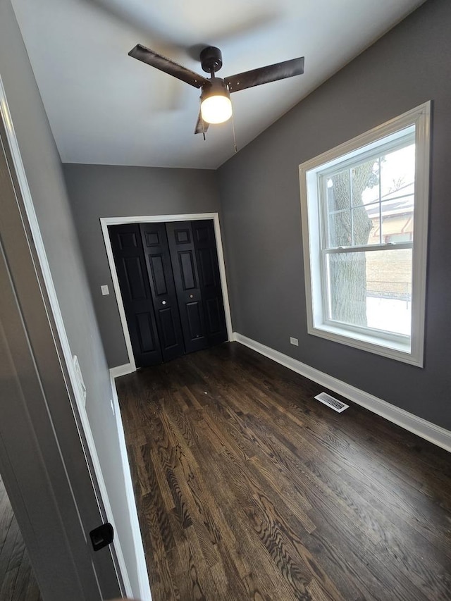2040 W Garfield Blvd, Chicago, IL 60609 - unfurnished bedroom featuring visible vents, a closet, baseboards, ceiling fan, and dark wood-style flooring
