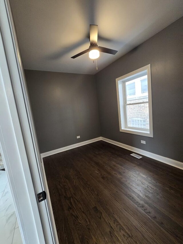 2040 W Garfield Blvd, Chicago, IL 60609 - unfurnished room featuring visible vents, a ceiling fan, baseboards, and dark wood-style flooring